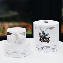 Load image into Gallery viewer, esprit infini scented candle in white cylindrical packaging with an eagle