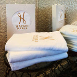 Ultra-soft cotton towel with texture embroidered logo pattern.
