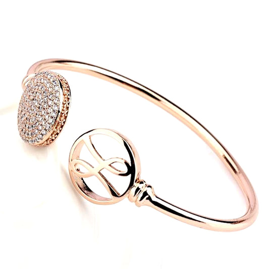 Pink gold bezel with 2 rounds on front with hayari logo