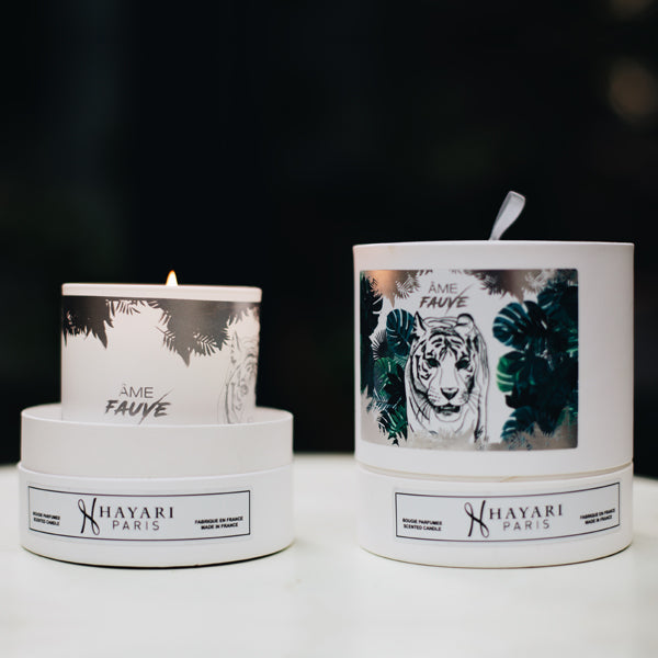 Ame fauve scented candle in white cylindrical packaging with a tiger in the jungle