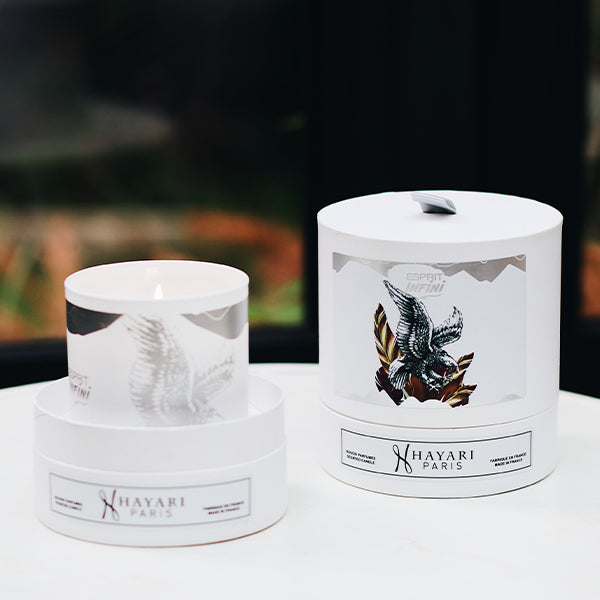 esprit infini scented candle in white cylindrical packaging with an eagle 