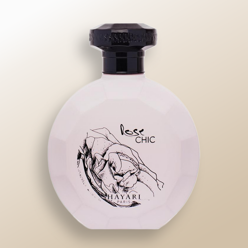 women perfume with a round matte pink bottle, black cap and rose drawn on it 