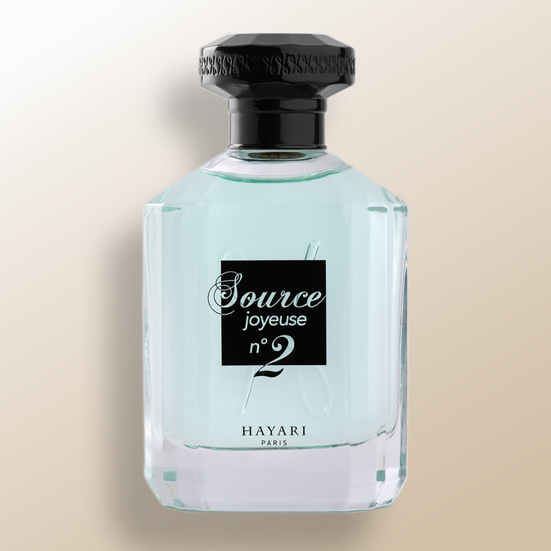 Source joyeuse n°2 eau de parfum in a clear bottle with black elements. Blue juice perfume